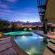 Arizona Estate infinity pool with outside view of trees and dusk sky